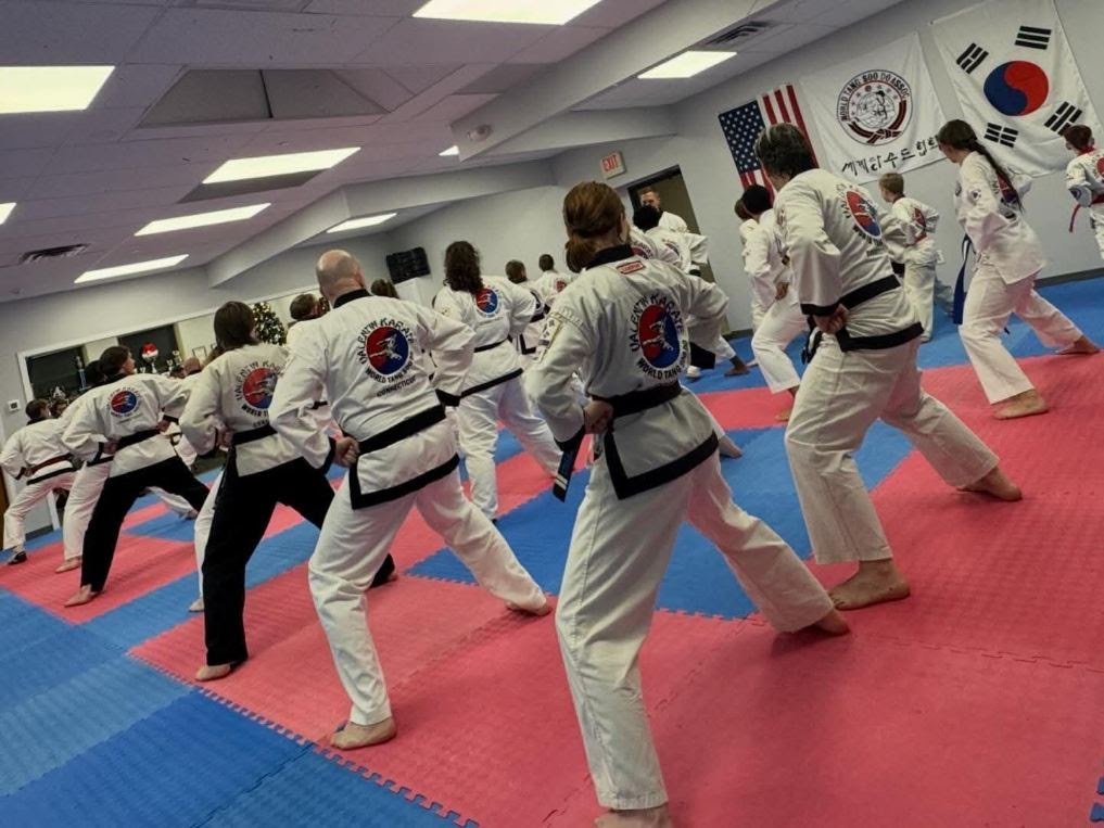Family lined up from behind in black-belt prep class